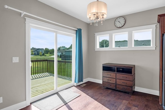 entryway with dark wood-style flooring, a wealth of natural light, and baseboards