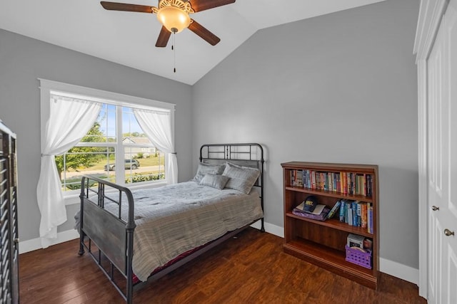 bedroom featuring ceiling fan, baseboards, vaulted ceiling, and wood finished floors