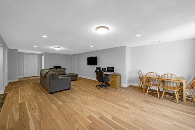 interior space with light wood-type flooring, baseboards, and recessed lighting