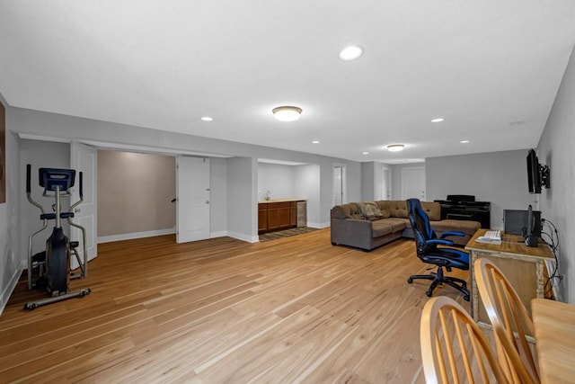 office area featuring recessed lighting, baseboards, and light wood finished floors