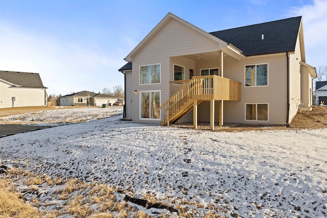 snow covered property featuring a wooden deck