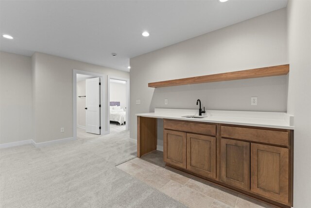 kitchen featuring sink and light carpet