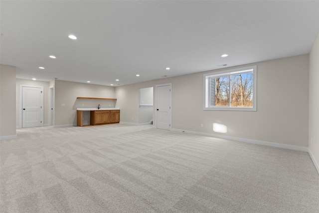 basement featuring light carpet