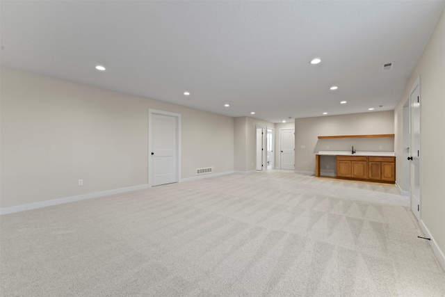 unfurnished living room with light colored carpet