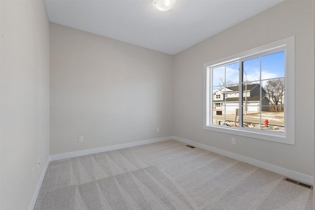 empty room with light colored carpet