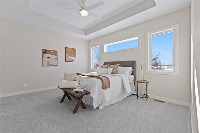 1028 2nd St NE, Altoona, IA 50009 - bedroom featuring a tray ceiling, light colored carpet, and ceiling fan