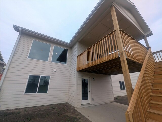 1028 2nd St NE, Altoona, IA 50009 - rear view of property featuring stairway, a patio area, and a deck