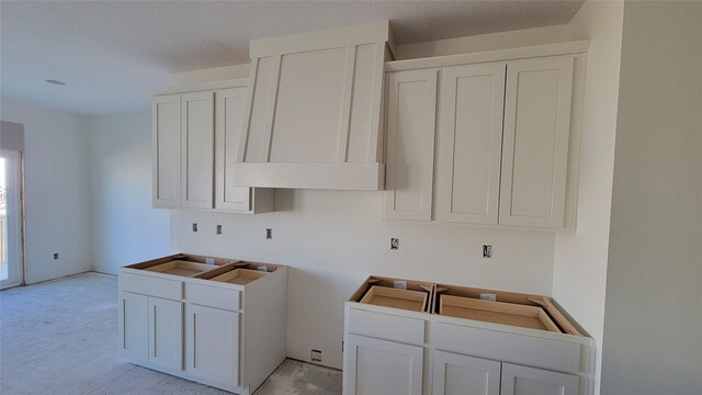 clothes washing area featuring a textured ceiling