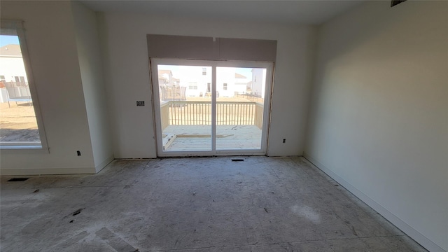 unfurnished room featuring plenty of natural light