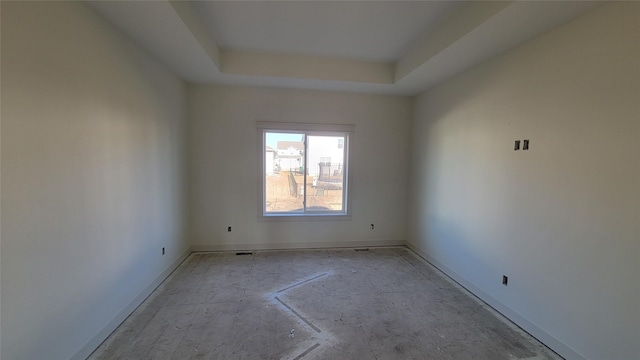 empty room with a raised ceiling