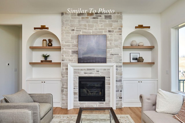 10622 NW 80th Ave, Johnston, IA 50131 - living area with light wood-type flooring, a glass covered fireplace, and built in shelves