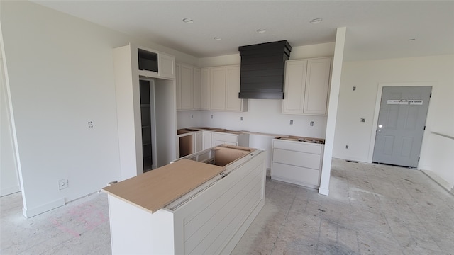 kitchen with a kitchen island and white cabinets