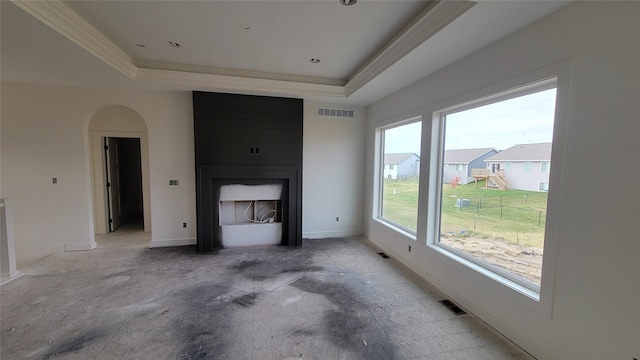 living room with a large fireplace and a tray ceiling