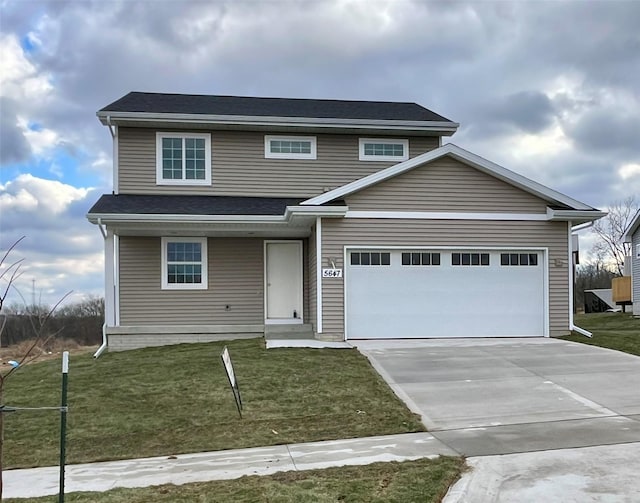 view of front of house featuring a front lawn and a garage