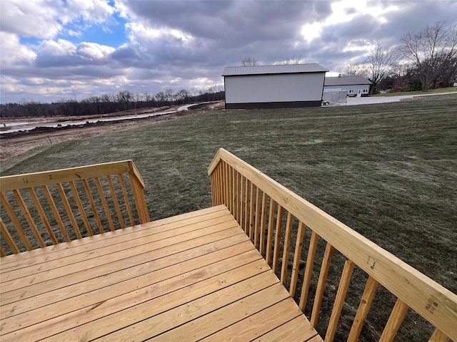 wooden deck with a yard and an outdoor structure