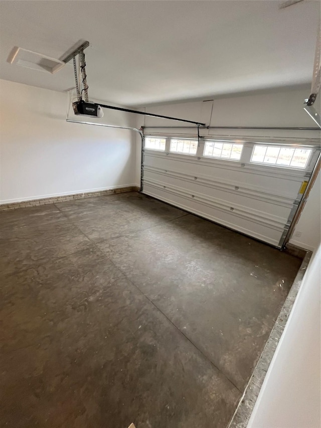 garage with baseboards and a garage door opener