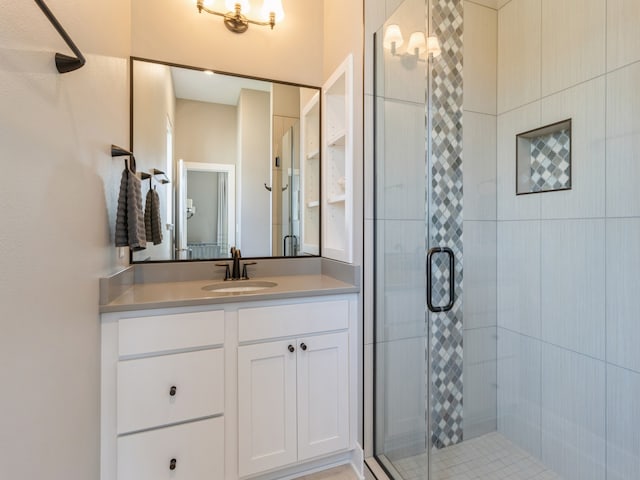 bathroom featuring walk in shower and vanity