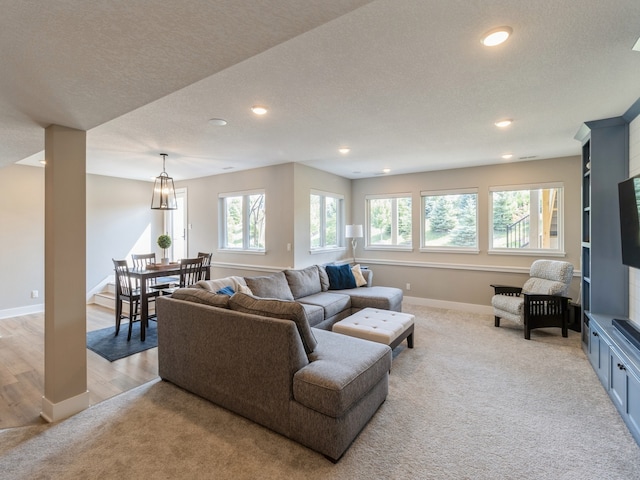 living room with light hardwood / wood-style floors and a textured ceiling