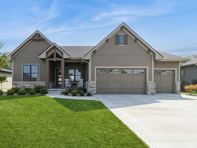 craftsman inspired home with a garage, a porch, and a front lawn