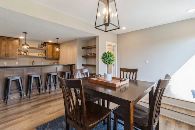 dining room featuring light wood-type flooring and sink