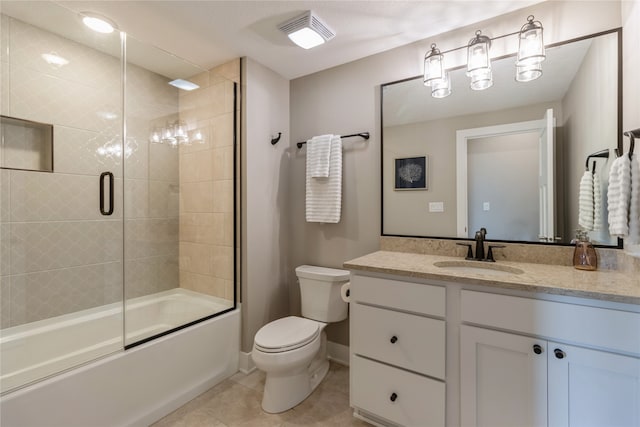 full bathroom with toilet, vanity, tile patterned floors, and enclosed tub / shower combo