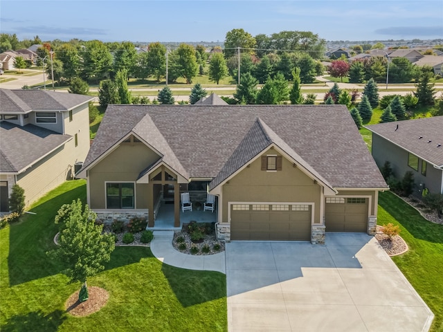 craftsman-style home featuring covered porch and a front yard