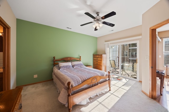 bedroom with light carpet, access to exterior, multiple windows, and visible vents