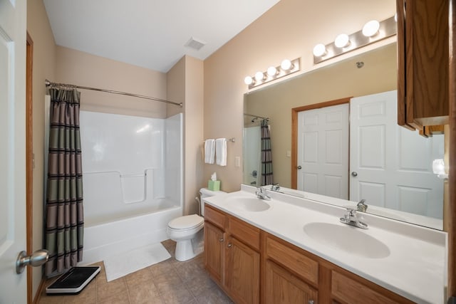 bathroom with visible vents, a sink, toilet, and double vanity