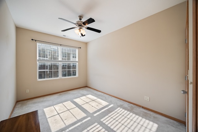 empty room with light carpet, baseboards, visible vents, and a ceiling fan