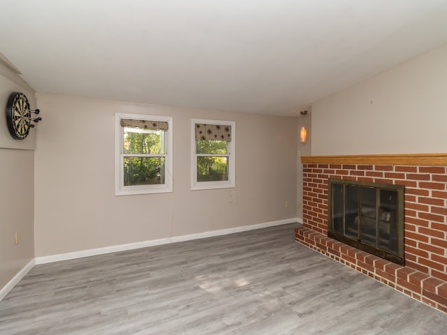 unfurnished living room featuring a fireplace and wood-type flooring