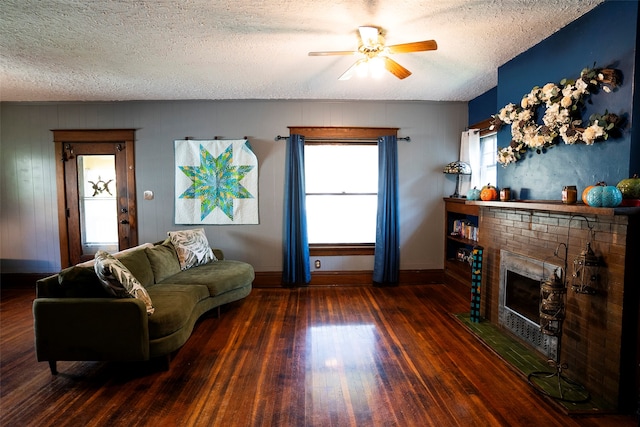 living room featuring plenty of natural light, ceiling fan, and a fireplace