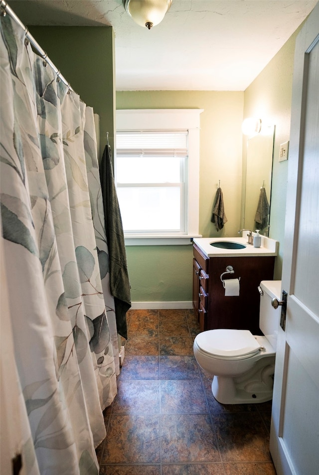 bathroom featuring vanity, toilet, and a shower with shower curtain