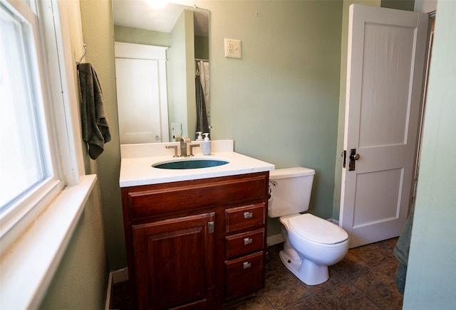 bathroom with tile patterned flooring, vanity, and toilet