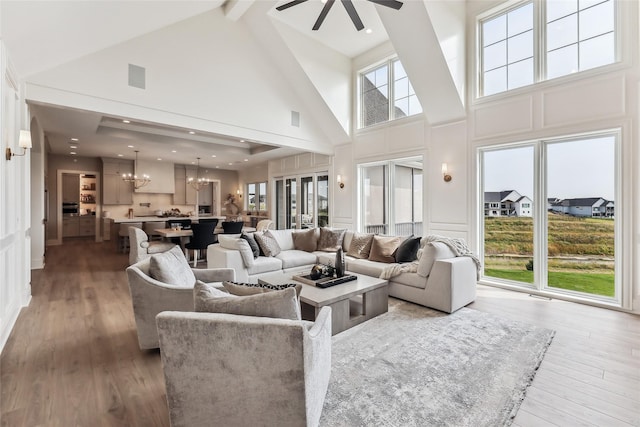 18252 Valleyview Cir, Clive, IA 50325 - living area featuring high vaulted ceiling, a chandelier, ceiling fan, beamed ceiling, and wood finished floors