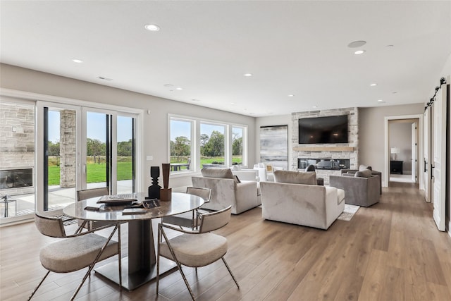 18252 Valleyview Cir, Clive, IA 50325 - dining space featuring a fireplace, light wood finished floors, and recessed lighting