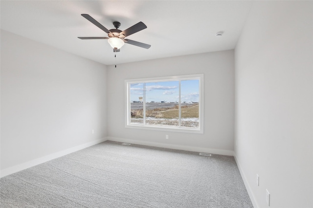 carpeted spare room featuring ceiling fan