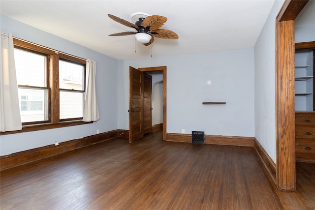 spare room featuring ceiling fan and dark hardwood / wood-style floors