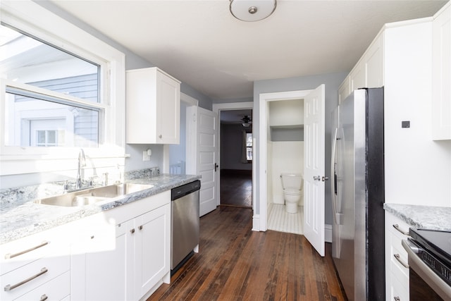 kitchen featuring white cabinetry, appliances with stainless steel finishes, sink, and dark hardwood / wood-style flooring