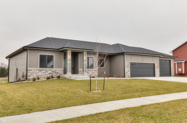 prairie-style house with a garage and a front lawn