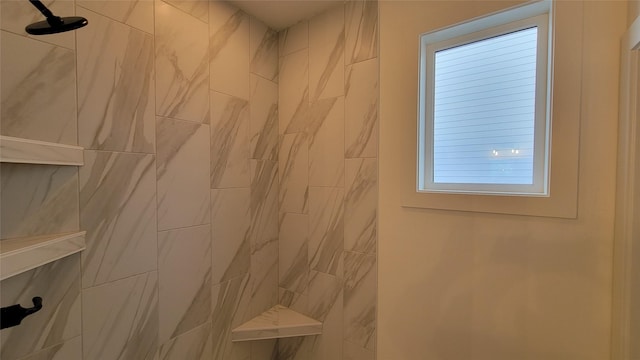 bathroom with tiled shower