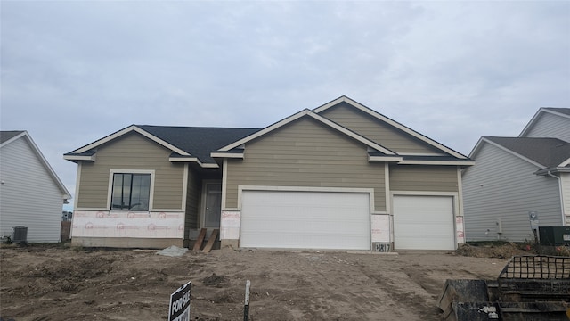 view of front of house featuring central AC and a garage