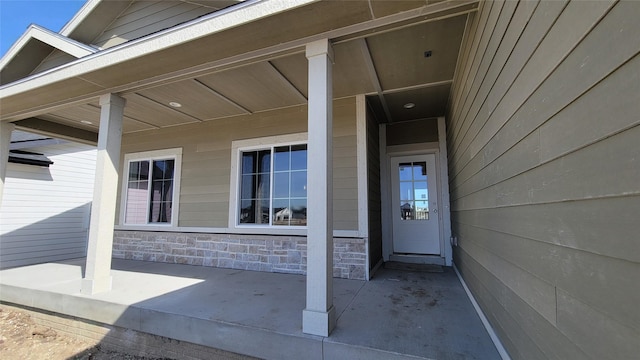 doorway to property with stone siding