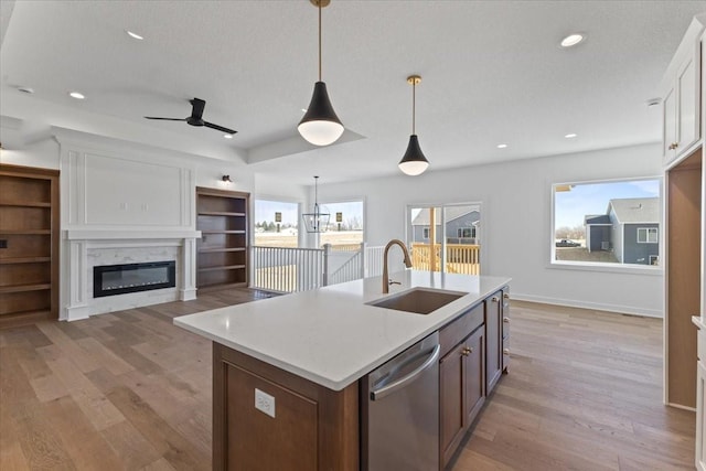 kitchen with a wealth of natural light, dishwasher, sink, and white cabinets