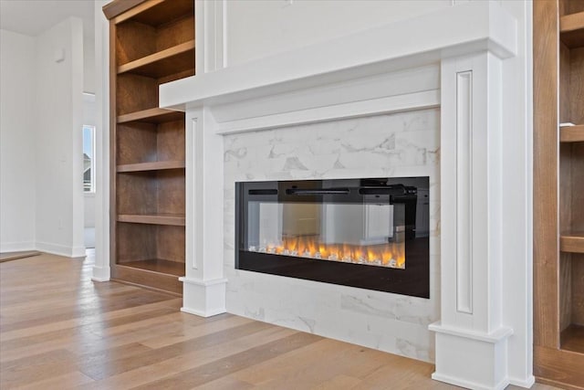 details with built in shelves and hardwood / wood-style flooring