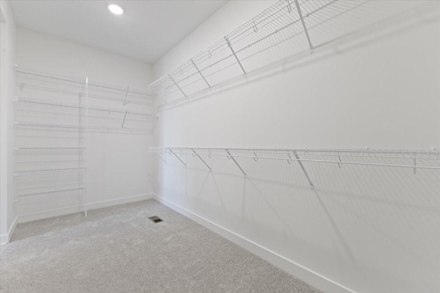 walk in closet with carpet