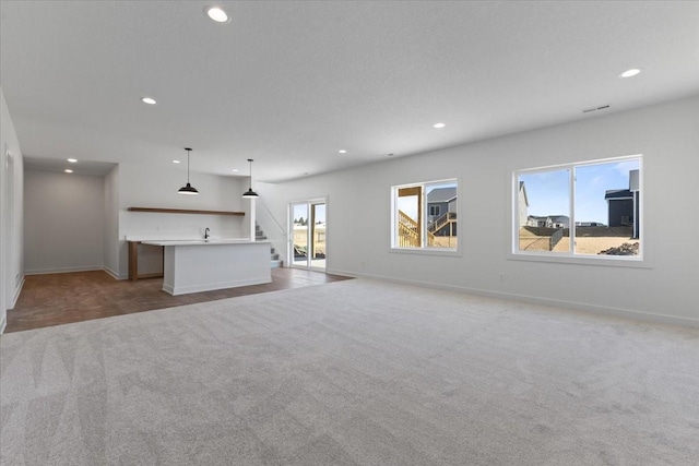 unfurnished living room featuring light colored carpet