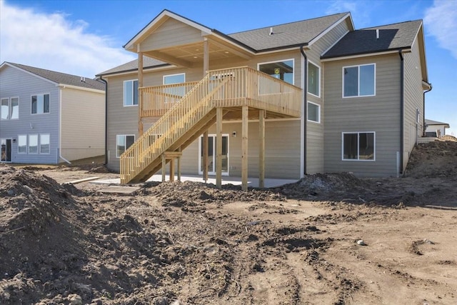 rear view of house featuring a deck and a patio area