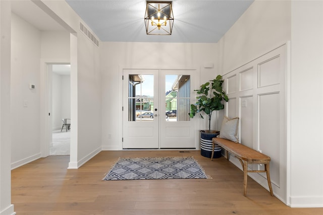 entrance foyer with light hardwood / wood-style flooring and french doors