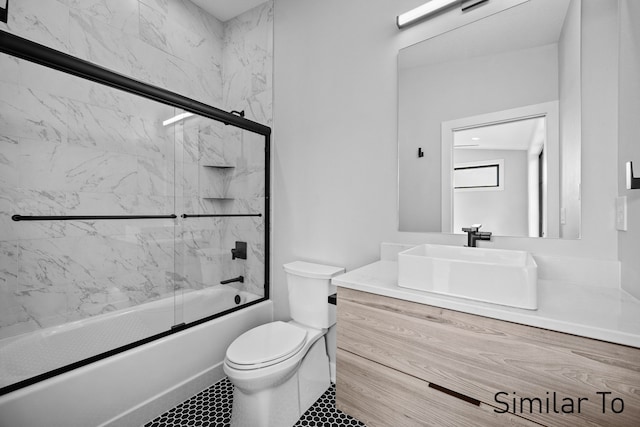 full bathroom featuring vanity, toilet, tile patterned floors, and enclosed tub / shower combo