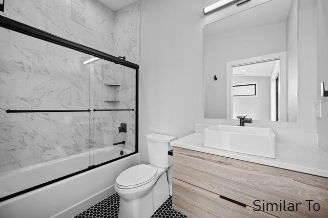 full bathroom featuring vanity, toilet, tile patterned floors, and enclosed tub / shower combo